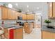 Bright eat-in kitchen with wood cabinets, stainless steel appliances, and an island at 9852 Caroline Park Dr, Orlando, FL 32832