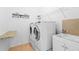 Functional laundry room with modern washer, dryer, utility sink, and ample shelving at 9852 Caroline Park Dr, Orlando, FL 32832