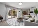 Bright living room with neutral tones, a large sectional, and a view to the outdoor dining area at 9852 Caroline Park Dr, Orlando, FL 32832