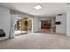 Bright living room with neutral tones and seamless views of the kitchen and outdoor dining area at 9852 Caroline Park Dr, Orlando, FL 32832