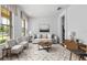 Bright living room with large windows, neutral tones, and stylish decor, creating an inviting atmosphere at 9852 Caroline Park Dr, Orlando, FL 32832