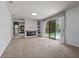Bright and airy living room with a modern fireplace and view of the pool at 9852 Caroline Park Dr, Orlando, FL 32832