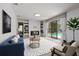 Bright and airy living room with a modern fireplace, blue couch, and view of the pool at 9852 Caroline Park Dr, Orlando, FL 32832