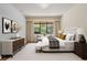 Comfortable main bedroom featuring soft lighting, neutral decor, and a view to the outside at 9852 Caroline Park Dr, Orlando, FL 32832