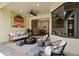 Cozy covered patio with stylish seating, ceiling fan, and access to the home's interior at 9852 Caroline Park Dr, Orlando, FL 32832