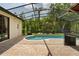 Backyard featuring a screened in pool area, patio, and an outdoor seating area at 9852 Caroline Park Dr, Orlando, FL 32832