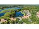 Aerial view of homes surrounding a lake with lush green trees and landscaping at 1070 Henley Downs Pl, Lake Mary, FL 32746