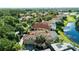 Aerial view of the house with a red tile roof, pool, and lush green surroundings at 1070 Henley Downs Pl, Lake Mary, FL 32746