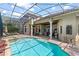 Spacious pool area features a covered patio and scenic views of the landscaped backyard at 1070 Henley Downs Pl, Lake Mary, FL 32746