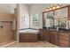 Bright bathroom with a large soaking tub, walk-in shower, and vanity with black countertop at 1070 Henley Downs Pl, Lake Mary, FL 32746