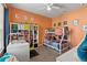 Bright bedroom featuring a bunk bed, colorful decor, and a white shelving unit and desk at 1070 Henley Downs Pl, Lake Mary, FL 32746