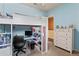 Well-lit bedroom with a lofted bed, desk, shelves, and a dresser for storage at 1070 Henley Downs Pl, Lake Mary, FL 32746
