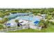 Aerial view of a resort-style pool with palm trees, cabanas, lounge chairs, and water slide perfect for relaxation at 1070 Henley Downs Pl, Lake Mary, FL 32746