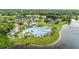 Aerial view of a resort-style pool with palm trees, cabanas, lounge chairs and water slide perfect for relaxation at 1070 Henley Downs Pl, Lake Mary, FL 32746