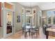Dining area with many windows showcasing a waterfront view of the pool at 1070 Henley Downs Pl, Lake Mary, FL 32746