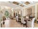 Open-concept dining area features a large wooden table, neutral decor, and seamless transition to the living room at 1070 Henley Downs Pl, Lake Mary, FL 32746