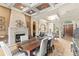 Elegant dining room with a stone fireplace, decorative ceiling, and an open layout to the living spaces at 1070 Henley Downs Pl, Lake Mary, FL 32746