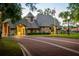 Charming gated community entrance with lush landscaping and brick-paved road in a residential neighborhood at 1070 Henley Downs Pl, Lake Mary, FL 32746