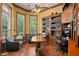 Spacious home office with lots of natural light, wood floors, and built-in bookshelves and cabinets at 1070 Henley Downs Pl, Lake Mary, FL 32746