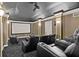 Home theater room with tiered seating, a large screen, and a projector for immersive entertainment at 1070 Henley Downs Pl, Lake Mary, FL 32746