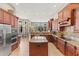 Gourmet kitchen featuring stainless steel appliances, granite countertops, and wood cabinets at 1070 Henley Downs Pl, Lake Mary, FL 32746