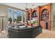 Open living room featuring a ceiling fan, large windows, and custom wood built-in shelving at 1070 Henley Downs Pl, Lake Mary, FL 32746