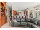 Living room showcasing a leather sectional couch, an adjacent staircase, and tile floors at 1070 Henley Downs Pl, Lake Mary, FL 32746