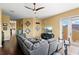 Comfortable living room featuring hardwood floors, a gray sofa, and a wall mounted TV at 1070 Henley Downs Pl, Lake Mary, FL 32746