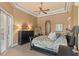 Main bedroom featuring tray ceilings, neutral walls, and private access to an outdoor patio at 1070 Henley Downs Pl, Lake Mary, FL 32746