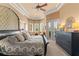 Main bedroom with tray ceiling, doors to the outside, and a large dresser at 1070 Henley Downs Pl, Lake Mary, FL 32746