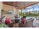 Covered patio offers a cozy seating area with a beautiful view of the pool and lake at 1070 Henley Downs Pl, Lake Mary, FL 32746