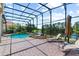 Screened-in pool with hot tub overlooks a serene lake, perfect for relaxation at 1070 Henley Downs Pl, Lake Mary, FL 32746