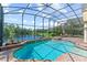 Inviting screened-in pool and spa area overlooking a peaceful lake, perfect for relaxation and entertaining at 1070 Henley Downs Pl, Lake Mary, FL 32746