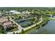 Aerial view showcasing the well-maintained tennis courts, surrounded by lush greenery and scenic views at 1070 Henley Downs Pl, Lake Mary, FL 32746
