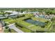 Aerial view of resort style tennis facilities with lush landscaping and a lake backdrop at 1070 Henley Downs Pl, Lake Mary, FL 32746