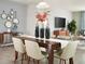 Elegant dining room with a wooden table, stylish chairs, and decorative mirrors on the wall at 1114 Cumberland Trail Dr, Lake Hamilton, FL 33851