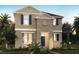 Two-story home featuring neutral paint, a charming entry, and manicured landscaping at 11164 Hollow Bay Dr, Winter Garden, FL 34787