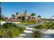 Relaxing hammock view of clubhouse with palm trees and native foliage is a great amenity for the community at 11182 Hollow Bay Dr, Winter Garden, FL 34787