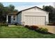 Charming single-story home featuring a two-car garage, stone accents, and lovely landscaping at 1123 Cumberland Trail Dr, Lake Hamilton, FL 33851