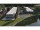 Stunning aerial view of modern townhomes with a community pool and beautifully landscaped grounds near the water at 11302 Westwood Blvd # 28, Orlando, FL 32821