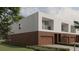 View of modern townhomes, highlighting sleek design and two-car garages at 11302 Westwood Blvd # 28, Orlando, FL 32821