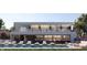 Upscale community pool area with lounge chairs, outdoor seating, and an adjacent fitness center overlooking the water at 11302 Westwood Blvd # 28, Orlando, FL 32821