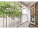 Balcony view overlooking lush greenery and parking area at 11526 Westwood Blvd # 735, Orlando, FL 32821