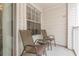 A charming balcony with two chairs and a small table at 11526 Westwood Blvd # 735, Orlando, FL 32821