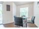 Cozy dining area features a glass table, stylish chairs, and natural light from a window at 11526 Westwood Blvd # 735, Orlando, FL 32821