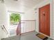 Exterior view of an apartment entrance with a red door at 11526 Westwood Blvd # 735, Orlando, FL 32821