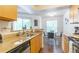 Kitchen with granite counters and wood cabinetry plus a cozy dining area with a view at 11526 Westwood Blvd # 735, Orlando, FL 32821