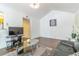 Bright living room with hardwood floors, vaulted ceiling, and comfortable black leather sofa at 11526 Westwood Blvd # 735, Orlando, FL 32821
