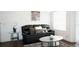 Cozy living room featuring a dark sofa, throw pillows, and a modern glass coffee table at 11526 Westwood Blvd # 735, Orlando, FL 32821
