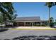 Community clubhouse featuring covered walkways, manicured grounds, and ample parking at 1241 Leatherwood Dr, Altamonte Springs, FL 32714